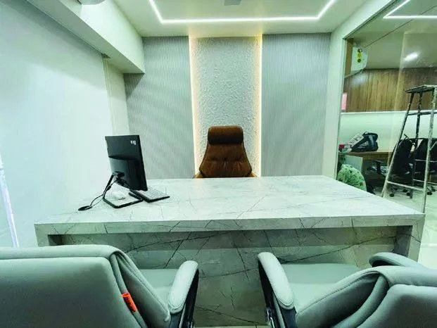 Director cabin with stone-finish desk and backlit panel