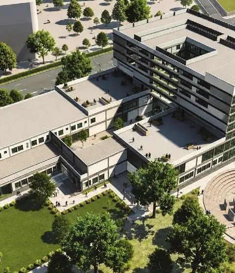 Aerial view of a college campus masterplan with academic blocks, green courts and an amphitheatre